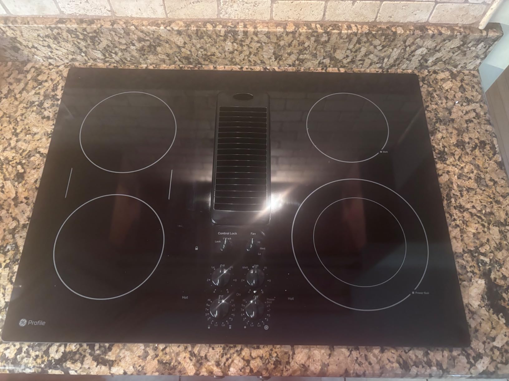 GE PP9830DJBB 30 Inch Smoothtop Electric Cooktop with 4 Burners, 3-Speed Downdraft Exhaust System, 9