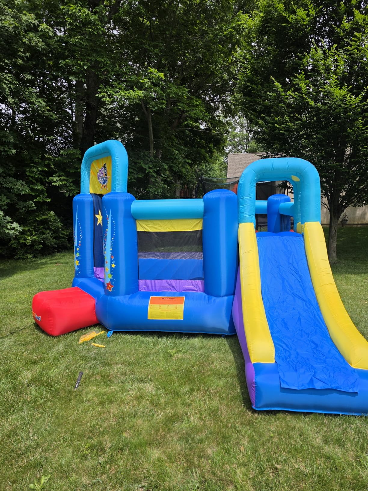 Bounceland Pop Star Inflatable Bounce House Bouncer, Large Bouncing Area with Long Slide, Climbing Wall, Basketball Hoop, UL 1HP Blower Included, 15 ft x 13 ft x 8.3 ft H, Pop Star Kids Party Theme customer photo 1